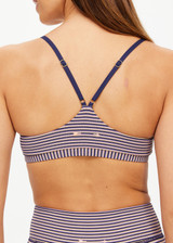 THE UPSIDE women's stripe print Solace Zoe Bra is made with Recycled Rib fabric designed for a supportive fit. This low-coverage bra features adjustable straps, ideal for yoga.
