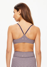 THE UPSIDE women's stripe print Solace Zoe Bra is made with Recycled Rib fabric designed for a supportive fit. This low-coverage bra features adjustable straps, ideal for yoga.