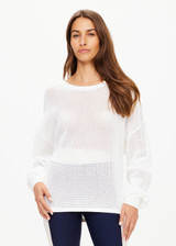 THE UPSIDE women's creme Fenway Sebastian Knit Crew is made with open knit organic cotton, for a relaxed fit. This long sleeve crew neck features a ribbed neckline and cuffs.