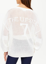THE UPSIDE women's creme Fenway Sebastian Knit Crew is made with open knit organic cotton, for a relaxed fit. This long sleeve crew neck features a ribbed neckline and cuffs.