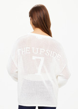 THE UPSIDE women's creme Fenway Sebastian Knit Crew is made with open knit organic cotton, for a relaxed fit. This long sleeve crew neck features a ribbed neckline and cuffs.
