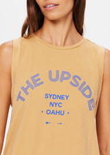 THE UPSIDE women's natural Jetset Jeet Tank is made with organic jersey cotton designed for a relaxed fit. This sleeveless tank features folded armhole details. A lifestyle essential.