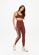 THE UPSIDE women's polka dot Maho 25 inch High Rise Midi Pant is made from a soft recycled ribbed fabric and features a soft folded waistband and contrast splice plan down the sides.