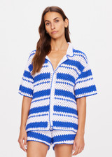THE UPSIDE women's tonal white and blue striped Haven Lovett Crochet button through Shirt is made from hand crocheted cotton and features a collar and pink buttons and contrast stripes.