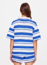 THE UPSIDE women's tonal white and blue striped Haven Lovett Crochet button through Shirt is made from hand crocheted cotton and features a collar and pink buttons and contrast stripes.