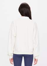 THE UPSIDE women's creme Pascal Collared Crew is made with organic french terry, designed for a relaxed fit. This classic crew features a built-in ribbed collar. A lifestyle essential.