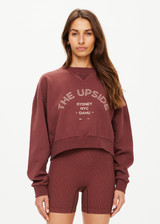 THE UPSIDE women's brown Jetset Dominique Crew cropped sweatshirt is made with organic cotton french terry, overdyed in plumberry, featuring a high neck band in soft rib.