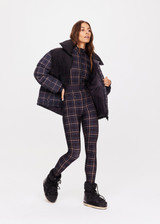 THE UPSIDE women's black check Lumiere Nova Jumpsuit is made in stretch fabric, for a soft fit. This all-in-one ski jumpsuit features thumbholes and a removable belt.