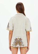 THE UPSIDE women's creme Vadella Collared Knit Shirt is made from organic cotton. It is a relaxed button up knit shirt and features a paisley design on a creme base. Designed for lounging and leisure.