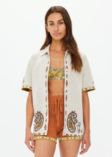 THE UPSIDE women's creme Vadella Collared Knit Shirt is made from organic cotton. It is a relaxed button up knit shirt and features a paisley design on a creme base. Designed for lounging and leisure.
