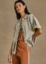 THE UPSIDE women's creme Vadella Collared Knit Shirt is made from organic cotton. It is a relaxed button up knit shirt and features a paisley design on a creme base. Designed for lounging and leisure.