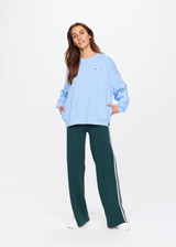 THE UPSIDE women's blue One Love Club Coolum Crew is made in brushed organic cotton. Fitted with a ribbed neckline, cuffs and hem for style and discreet side seam pockets for practicality. Designed for walking and recovery.