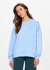 THE UPSIDE women's blue One Love Club Coolum Crew is made in brushed organic cotton. Fitted with a ribbed neckline, cuffs and hem for style and discreet side seam pockets for practicality. Designed for walking and recovery.