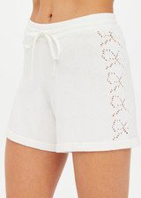 THE UPSIDE women's white Lavalliere Rosie Knit Short is made from organic cotton with an elasticated waist. It features an open lace knit construction with bow knitted detailing at sides for an elevated look. Designed for golf.