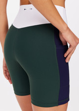 THE UPSIDE women's green Playoff 6inch Pocket Spin Short is made from a recycled soft peached fabrication with a brushed handfeel for a breathable and quick drying effect. The active shorts are paired with colours of navy and white and featuring side pockets for practicality. Designed for golf.