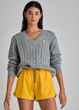 THE UPSIDE women's grey Seymour Cable Knit Sweater is made from organic cotton. Featuring a V shape neckline and ribbed cuffs, hem and neckline for comfort and style. Designed for leisure and recovery.