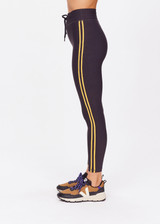 THE UPSIDE women's black Beaufort 25 inch Midi Pant is made from recycled soft peached fabrication with a brushed handfeel for a breathable and quick drying effect. The mid rise pant features an elasticated drawcord for the perfect fit and yellow stripes down the side for style. Designed for the gym and running.