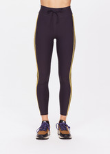 THE UPSIDE women's black Beaufort 25 inch Midi Pant is made from recycled soft peached fabrication with a brushed handfeel for a breathable and quick drying effect. The mid rise pant features an elasticated drawcord for the perfect fit and yellow stripes down the side for style. Designed for the gym and running.