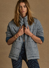 THE UPSIDE women's denim blue oversized Daria quilted zip-through jacket, made from organic cotton jersey, feature welt pockets and a tan apple leather patch at the back neck.