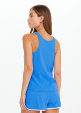 THE UPSIDE women's bright blue Wrangler Issy Racerback Tank Top is made from recycled mesh fabrication and features a curved hem.