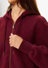 THE UPSIDE women's maroon oversized Ryder Jude Crop Zip-Up Hoodie is made from organic cotton and feature ribbed cuffs and a hemband.
