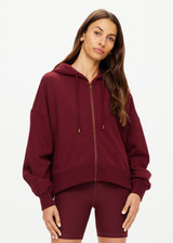 THE UPSIDE women's maroon oversized Ryder Jude Crop Zip-Up Hoodie is made from organic cotton and feature ribbed cuffs and a hemband.