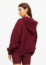 THE UPSIDE women's maroon oversized Ryder Jude Crop Zip-Up Hoodie is made from organic cotton and feature ribbed cuffs and a hemband.