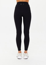 THE UPSIDE women's Peached 25 Inch Pocket legging is a mid rise 7/8 length leg in black with side pockets and a stretch drawcord waistband. The fabric is breathable and quick drying.