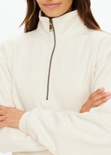 THE UPSIDE women's white organic cotton Hamilton Wren Half Zip Sweater is designed for a regular fit and features a embroidered horseshoe logo. Perfect for everyday.