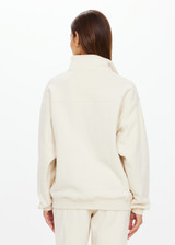 THE UPSIDE women's white organic cotton Hamilton Wren Half Zip Sweater is designed for a regular fit and features a embroidered horseshoe logo. Perfect for everyday.