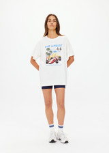 THE UPSIDE women's cream organic cotton Raceway Sammi Tee is designed for an oversized fit with printed raceway graphics on the front.