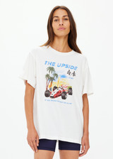 THE UPSIDE women's cream organic cotton Raceway Sammi Tee is designed for an oversized fit with printed raceway graphics on the front.
