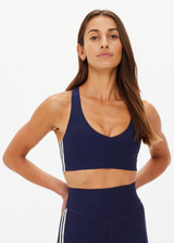 THE UPSIDE women's navy recycled peached Daytona Jetta Racerback Sports Bra is designed for a supportive fit and features removable cups. Made for yoga & pilates.