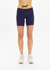 THE UPSIDE women's navy recycled peached Daytona 6 Inch Spin Short is designed for a mid-rise fit featuring contrast cream binds. Made for yoga & pilates.