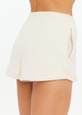THE UPSIDE women's creme organic cotton Hamilton Dee Short is designed for a regular fit, featuring a elasticated waistband with side seam pockets. Made for everyday.