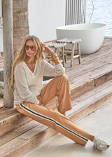 THE UPSIDE women's creme organic cotton Josephine V Neck Knit is a lightweight open knit designed for a relaxed fit with a deep V neckline. Made for everyday.