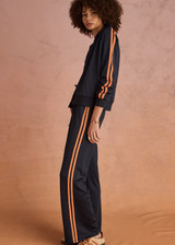 THE UPSIDE women's navy Vitesse Pari Zip Jacket comes in a slinky fabrication with mesh side tapes in contrast orange and side pockets. Designed for everyday leisure.
