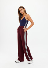THE UPSIDE women's merlot Vitesse Marine Wide Leg Pant is a high rise fit and features a elasticated waistband, drawcord and side seam pockets in slinky fabrication. Made for lifestyle.