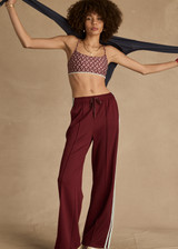 THE UPSIDE women's merlot Vitesse Marine Wide Leg Pant is a high rise fit and features a elasticated waistband, drawcord and side seam pockets in slinky fabrication. Made for lifestyle.