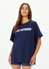 THE UPSIDE women's navy organic cotton Stardust Sammi Tee is designed for an oversized fit and features printed puff logo at front. Made for lifestyle.