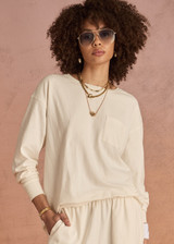 THE UPSIDE women's cream recycled cotton Soho Cara Long Sleeve Top is designed for a relaxed fit and features a ribbed neck and cuffs and a patch pocket at front. Made for everyday leisure.