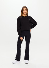 THE UPSIDE women's black Peached Florence Flare is a high-rise full length flare pant with V waistband and a printed arrow logo on back waistband.