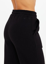 THE UPSIDE women's black organic cotton Willow Wide Leg Pant is a high-waisted, relaxed fit and features an elasticated waistband with drawcord and side seam pockets. Made for lifestyle.