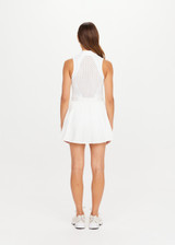 THE UPSIDE women's white Slam Pleated Tennis Dress features a quarter zip opening with mock neck, a pleated light-weight skirt with built-in inner short with pockets. Made for tennis.