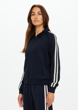 THE UPSIDE women's black Empire Pari Zip Jacket fits true-to-size and features a zip-through opening and knitted cream stripes down sides with a hint of silver metallic. Made for lifestyle.