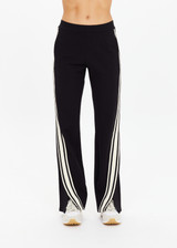 THE UPSIDE women's black Petra Flare Pant is made from soft suiting fabric and features elasticated waistband, side pockets and contrast cream stripes down side seams. Made for lifestyle.