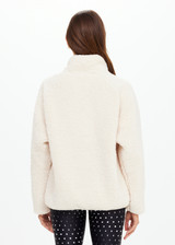 THE UPSIDE women's natural Harlow Fleece Pullover offers a relaxed fit made from recycled warm fleece fabric and features zip pockets and an elastic at waist and cuffs to keep warmth in. Made for lifestyle.