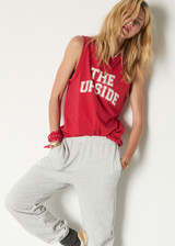 THE UPSIDE women's red organic cotton Jeet Tank Top has a relaxed fit with folded armhole detail and cream varsity logo at chest. Made for everyday wear.