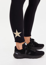 THE UPSIDE women's black recycled peached Celestia 25inch Legging is a soft & supportive fit and features a drawcord and printed star and horseshoe on ankles. Made for yoga & pilates.