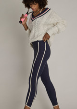 THE UPSIDE women's navy recycled peached Samara 25inch Legging is a soft & supportive fit and features side pockets and contrast cream stripes with curved hem detail. Made for pilates.